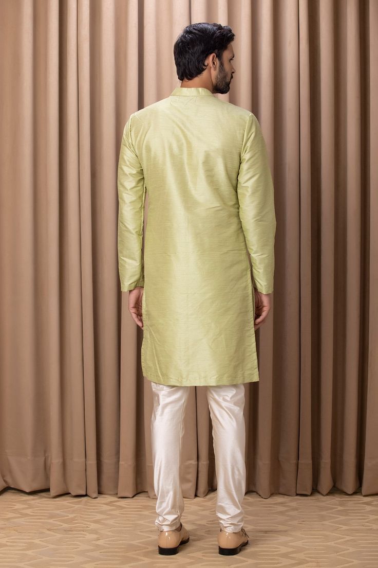 Mint green kurta with embroidered yoke. Comes with an ivory churidar.
Component: 2
Pattern: Embroidered
Neckline: Mandarin Collar
Sleeve Type: Straight Long
Fabric: Cotton and Silk
Color: Green
Other Details: 
Front concealed button placket
Side pockets
Occasion: Mehendi and Puja - Aza Fashions Kurta Set For Men, Embroidered Neckline, Churidar, Kurta Set, Embroidered Silk, Green Cotton, Mandarin Collar, Aza Fashion, Button Placket