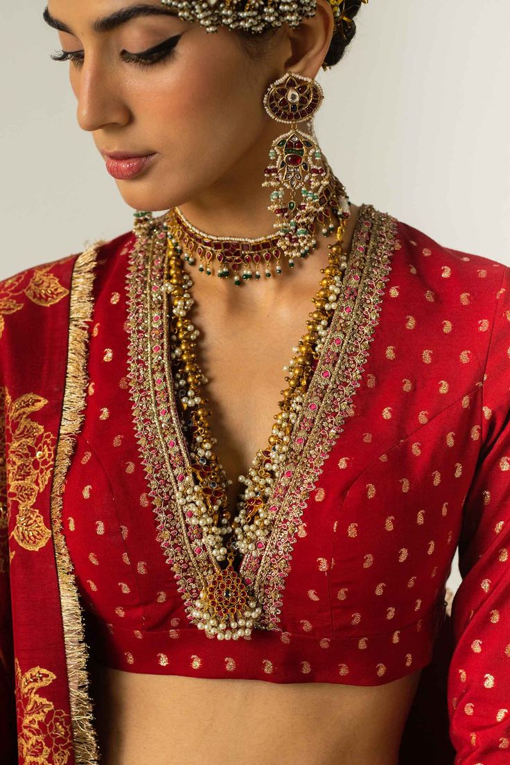 PRODUCT DESCRIPTION: Top: Zari JacquardBottom: Zari Jacquard & Raw SilkDupatta: Organza Complete your wedding wardrobe with this bold red ensemble. The red choli is paired with a kalidaar lehenga, with gota details and a dupatta with kiran and sitara spray all over. Zara Shahjahan, Wedding Wardrobe, New Saree Blouse Designs, Lehenga Blouse Designs, Fashionable Saree Blouse Designs, Blouse Designs Indian, Elegant Blouse Designs, Unique Blouse Designs, Saree Blouse Designs Latest