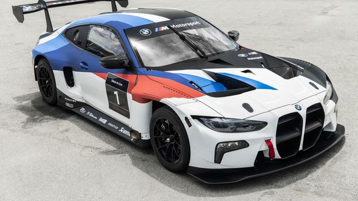 the bmw race car is painted in blue, white and red