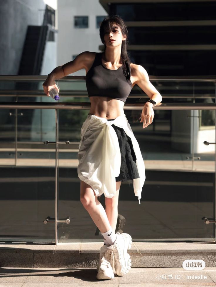 a woman is standing on the steps with her arms crossed