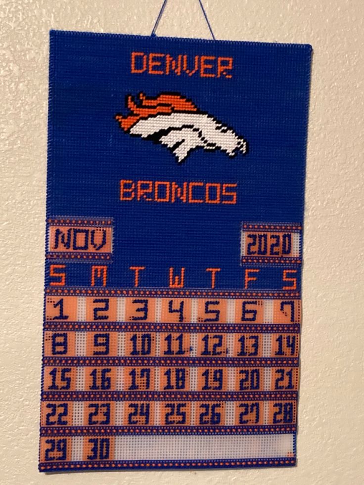 a sign hanging on the wall that says denver, denver and denver football teams are depicted