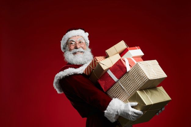 a man dressed as santa claus holding presents