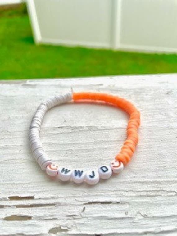 WWJD orange and white bracelet Casual Orange Jewelry For Friendship, Casual Handmade White Friendship Bracelets, Casual White Handmade Friendship Bracelets, Casual Handmade White Friendship Bracelet, Personalized Orange Bracelets As Gift, Casual Orange Bracelet For Friendship, Personalized White Wristband Bracelet, Orange Bracelets With Letter Beads As Gift, Orange Bracelets With Letter Beads For Gift