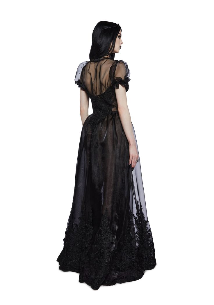 where for out thou lover. This maxi dress has a sheer lace construction, ruffled puff sleeves, floral appliques, and a lace trim. Black Gothic Lace Dress, Black Lace Gothic Dress, Goth Dress Aesthetic, Edgy Prom Dress, Black Wedding Dresses Gothic, Goth Dress Formal, Gothic Style Outfit, Gothic Formal Dress, Romantic Goth Dress