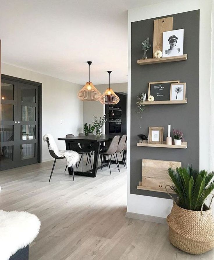 a dining room and kitchen area with wood flooring, gray walls and white furniture