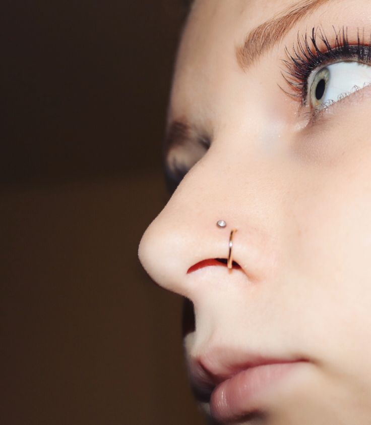 a woman's nose has a piercing on it