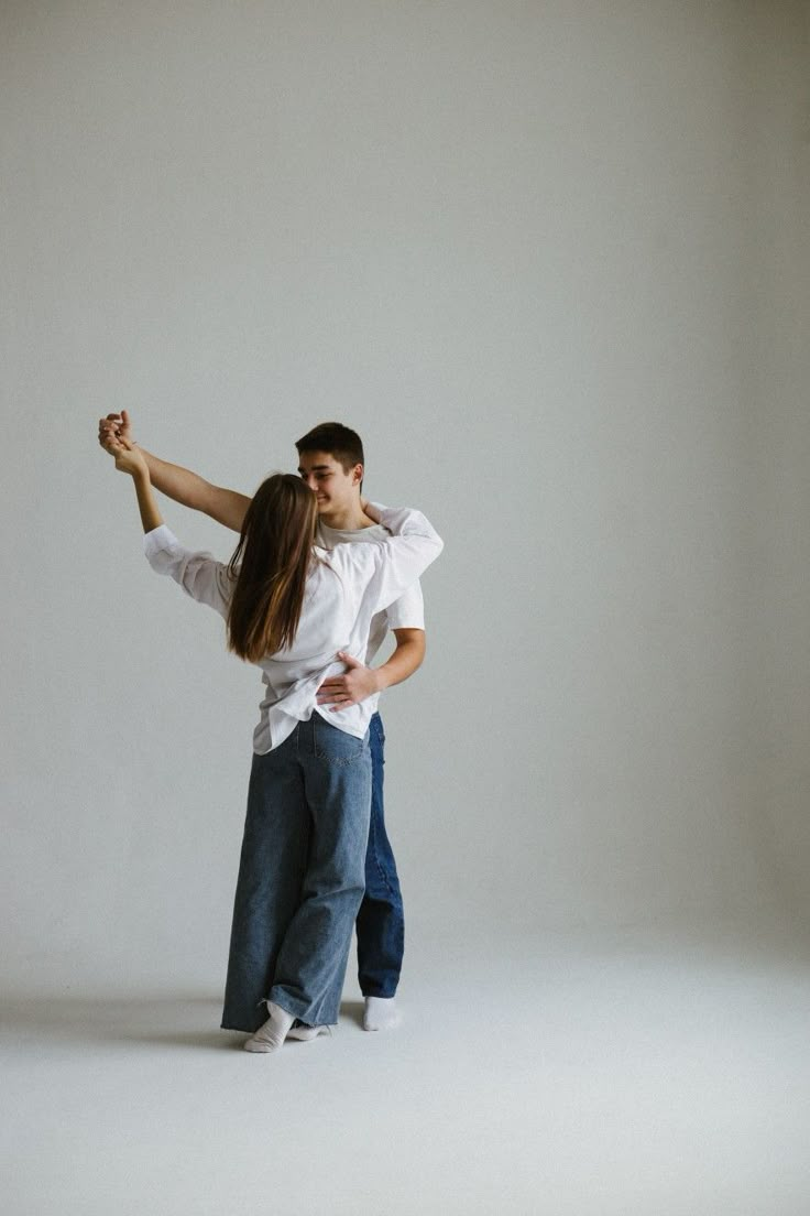 a man and woman dance together in the studio