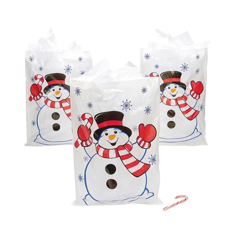 two bags with snowmen on them and one has a candy cane in front of it