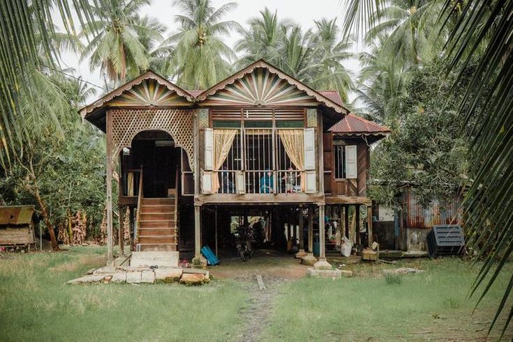 an old wooden house with palm trees in the background stock photo, picture and royalty