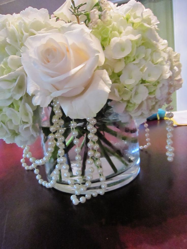 a vase filled with white flowers on top of a table