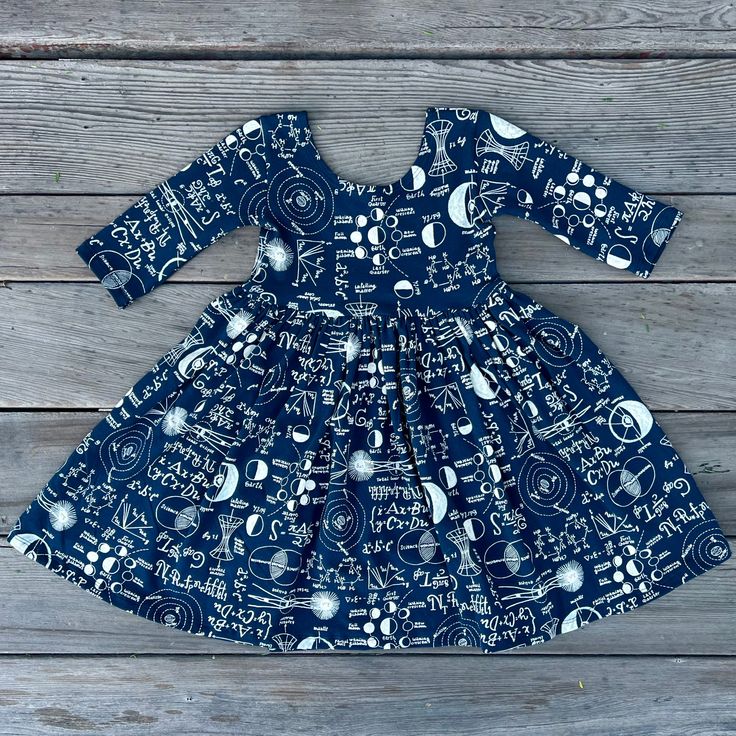 Celebrate the joy of learning with our 'Little Scientist' Navy Blue Dress, a charming and educational ensemble for your budding genius. This delightful dress features a rich navy blue hue adorned with playful math and science equations, making it the perfect fusion of style and STEM education. Crafted for comfort and curiosity, the dress is made from soft, breathable Cotton fabric, allowing your little one to explore the world while embracing the wonders of mathematics and science. The engaging Science Dress, Student Gift Ideas, Math Dress, Gift Ideas Kids, Girls Navy Dress, Navy Girl, Kids Science, Navy Girls, Student Gift