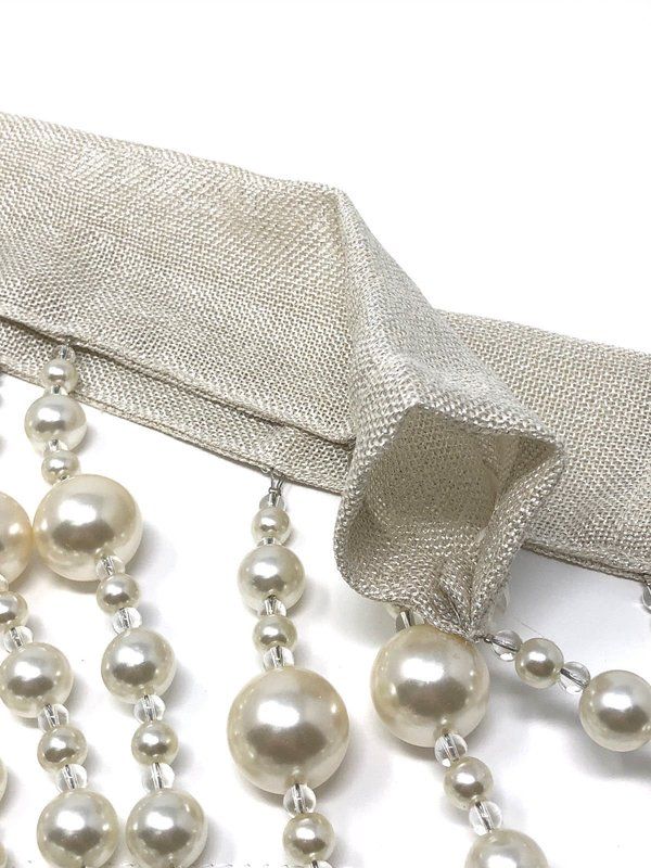 a pair of pearls hanging from a tie