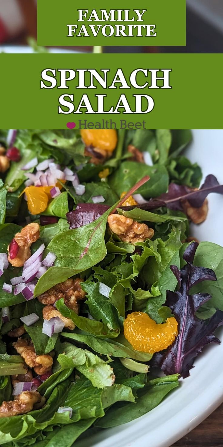 spinach salad with oranges and walnuts in a white bowl