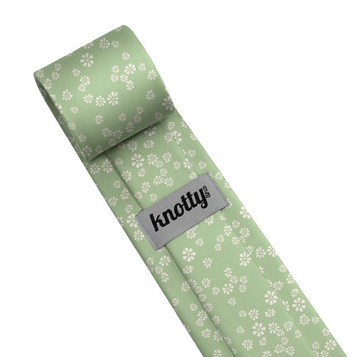 This minimalist floral design evokes simplicity with the peppering of wild daisies throughout. Green Ties For Spring Gift, Green Tie For Spring Gift, Green Ties As Spring Gifts, Elegant Floral Print Ties For Spring, Adjustable Ties For Business In Spring, Spring Business Adjustable Tie, Classic Floral Print Ties, Spring Floral Print Business Ties, Classic Floral Suit And Tie Accessories For Spring