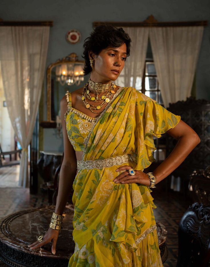 Editor's Note Presenting a stunning lime yellow pre-stitched sari, featuring our signature print, paired with a heavily hand-highlighted silk base blouse. The blouse is adorned with kowri shell detailing, adding a touch of elegance and uniqueness to the ensemble. Complete with a signature belt, this saree set exudes style and grace. Step into any occasion with confidence, draped in this captivating lime yellow saree that effortlessly combines traditional elements with contemporary flair. Color: Jacquard Lehenga, Paulmi And Harsh, Tissue Dupatta, 1950’s Fashion, Lime Yellow, Ruffle Saree, Dress And Jacket Set, Yellow Saree, Drape Saree