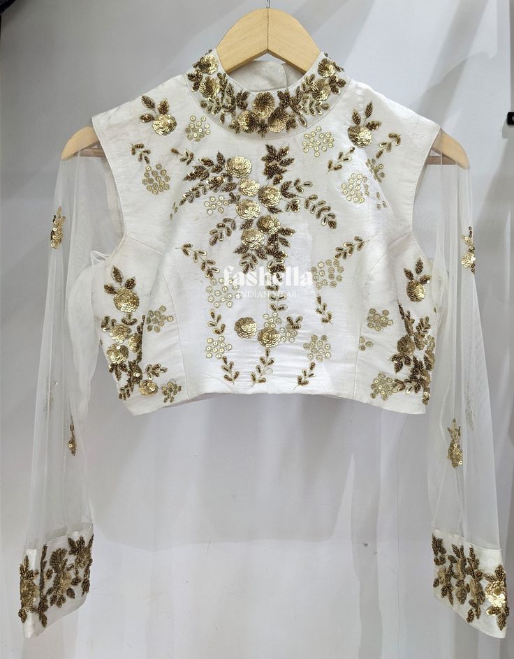 Beautiful Hand Embroidered white and gold blouse! This beautiful blouse can be paired with any sari or lehenga! MEAUREMENTS & CUSTOMIZATIONS This blouse can be made in ANY COLOR. Please drop us a convo to choose your preferred color.  This blouse can be purchased in your standard sizing and pattern. Please choose your Chest Size (measured in inches) from the drop-down box. For custom sizing please include the below measurements in the the notes to whenever you placed the order.  * Chest size: * Waist size: * Blouse Length: * Bicep: * Arm-hole: * Sleeve Length: * Front Neck Depth: * Back-Neck Depth:  SHIPPING DETAILS  Please leave your contact number in notes section while placing the order OR message us later. The shipping companies need your contact number incase they need to contact you White Blouse For Eid Reception, White Blouse Piece For Reception And Transitional Season, Elegant Embroidered Top For Diwali, White Traditional Drape Blouse For Reception, White Choli With Resham Embroidery For Transitional Season, Transitional White Choli With Resham Embroidery, Transitional Season White Choli With Resham Embroidery, Transitional White Choli With Intricate Embroidery, Festive Embroidered Top With Zari Work For Eid