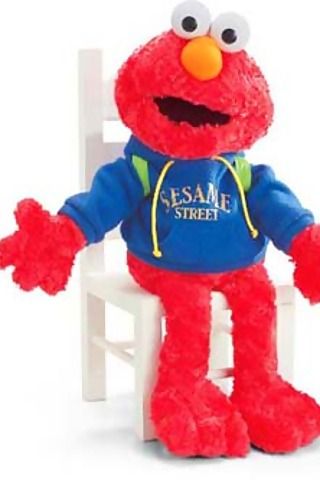 the sesame street character is sitting in a chair