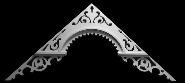 a white metal letter with an intricate design on the front and back side, against a black background