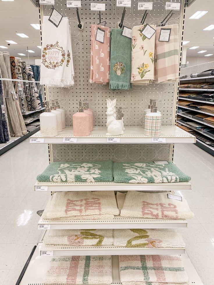 a store display with towels and other items on the shelves in front of it,