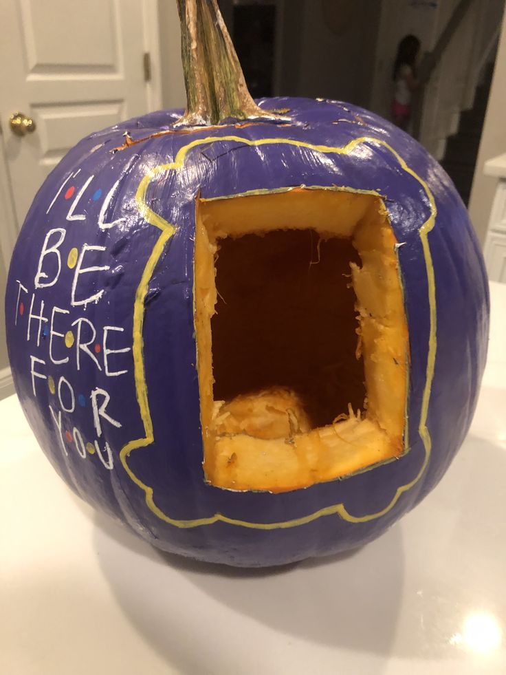 a purple pumpkin with writing on it