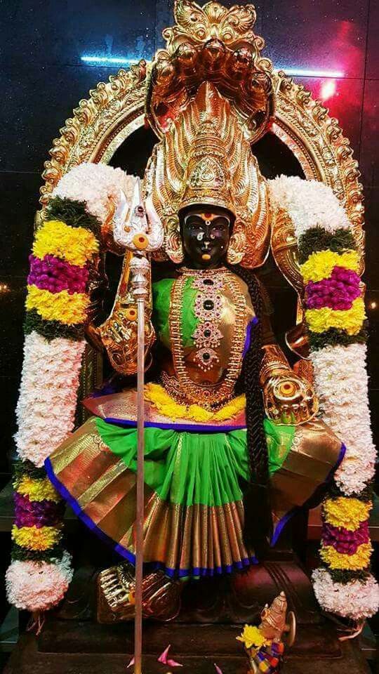 the statue is decorated with flowers and garlands