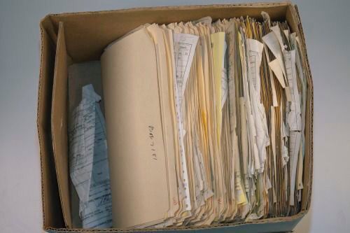 an open file box filled with files and papers