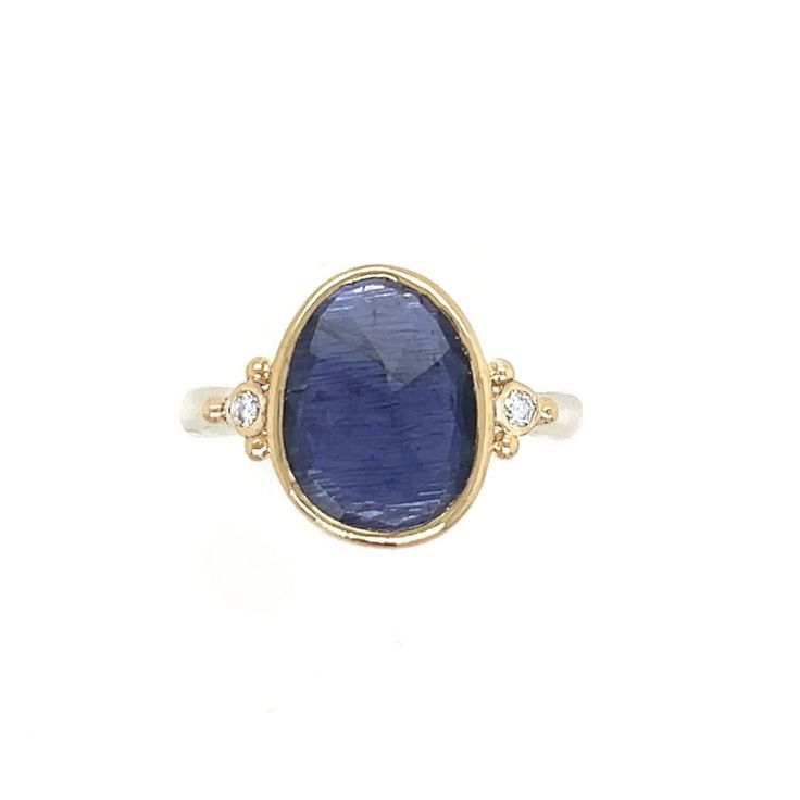 A vibrant purple Iolite is set between two brilliant white diamonds. Set in 14k yellow gold with a sterling silver seagrass band this ring will quickly become a favorite. Approx stone size: 13mm x 10mm Approx stone weight: 2.4cts Mohs Hardness: 7-7.5 This one of a kind piece is handmade with love in Emily's Hudson Valley studio. If you have questions about sizing, shipping or need help deciding on your perfect piece please reach out to us! Tanzanite Yellow Gold Rings With Diamond Accents, Yellow Gold Tanzanite Rings With Diamond Accents, Sterling Silver Yellow Gold Sapphire Ring With Center Stone, Yellow Gold Tanzanite Sapphire Ring With Accent Stones, Yellow Gold Sapphire Ring With Tanzanite And Accent Stones, Sterling Silver Sapphire Rings With Rose Cut Diamonds, Sapphire Rings With Rose Cut Diamonds In Sterling Silver, Yellow Gold Sterling Silver Rings With Gemstone Accents, Stacked Engagement Ring