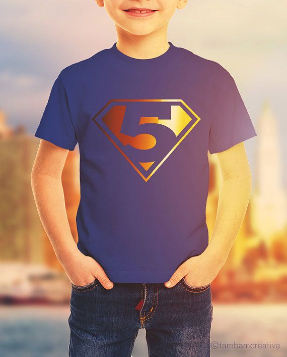 a young boy wearing a superman t - shirt with the number 5 on it's chest