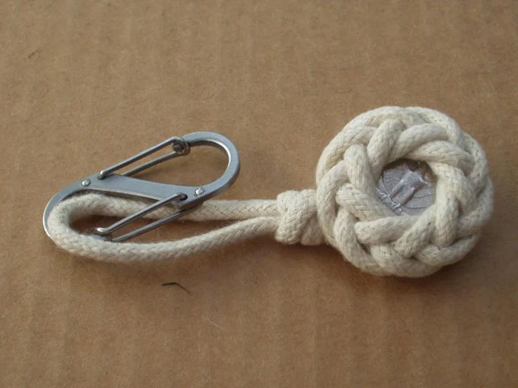 a white rope with a knot on it and a pair of scissors next to it