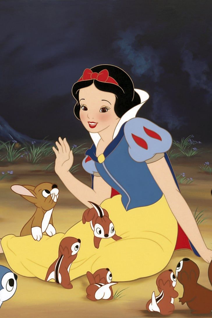 snow white sitting on the ground surrounded by puppies