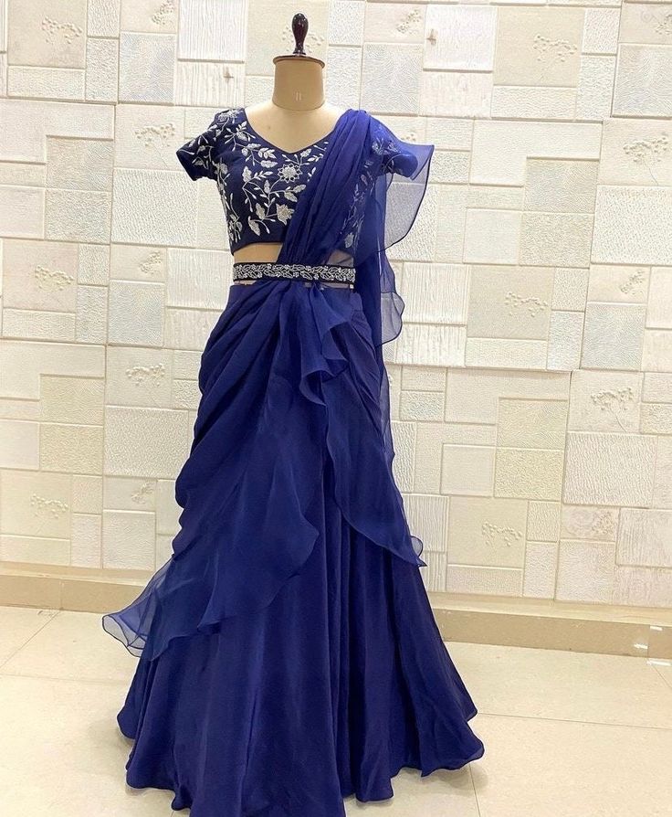 Ruffle saree with blouse/ blue  ruffle saree with stitched blouse/ saree belt with blouse / silk ruffle saree / blue ready  saree with belt / belt sari/ voggish /blue  cocktail lehenga saree     Here is the beautiful modern ruffle saree style lehenga in blue color paired with hand embroidered designer blouse and matching embroidered belt as shown !! Perfect and stands out in any occasion!! can be customized in any color !!  Fabric details :   Saree : soft chinnon and organza  Blouse/belt : pure raw silk  with hand embroidery   Blouse length - 15 inch Sleeves - short sleeves about 6 inch length ( can be customized)  - All our pictures are raw , unedited and took in natural light to get accurate colors but there might be slight color variations!! - please note that the item might ship from U Blue Ruffled Saree For Reception, Blue Saree With Ruffles For Reception, Formal Pre-draped Saree With Ruffles, Blue Choli With Ruffles And Traditional Drape, Blue Party Choli With Ruffles, Blue Ruffled Lehenga For Party, Fitted Silk Saree With Ruffles, Blue Lehenga With Ruffles And Traditional Drape, Blue Ruffled Pre-draped Saree For Party