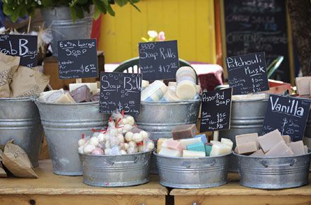 several buckets filled with different types of candies and marshmallows for sale