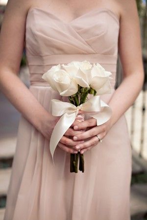 a woman in a dress holding a bouquet of flowers