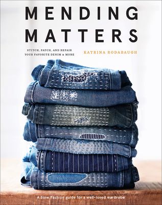 the book cover for mending matters, featuring jeans stacked on top of each other