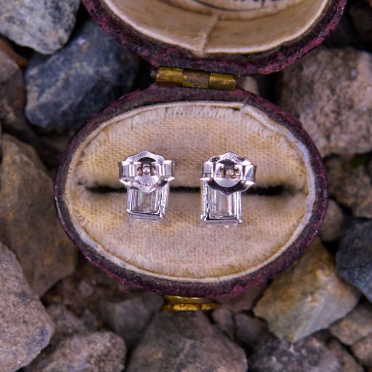 This lovely pair of emerald cut diamond stud earrings each feature one (1) emerald cut diamond set into a four-prong setting. The earrings are finished with friction backs and posts for pierced ears. Platinum Octagon Baguette Diamond Jewelry, Platinum Baguette Cut Diamond Earrings For Anniversary, Platinum Earrings With Baguette Diamonds For Gift, Baguette Cut Platinum Diamond Earrings For Anniversary, Gift Earrings With Baguette Diamonds In Platinum, Emerald Cut Diamond White Earrings With Diamond Accents, Emerald Cut Diamond White Earrings With Accents, Diamond White Emerald Cut Diamond Earrings, Emerald Cut Diamond Earrings In White Gold