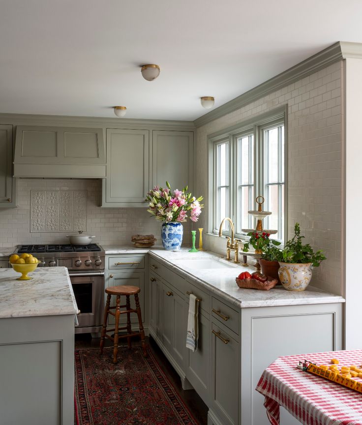 a kitchen with an island, sink, stove and counter top in the middle of it