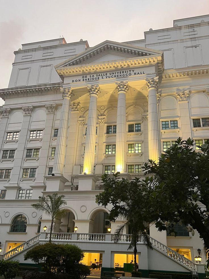 a large white building with columns and lights