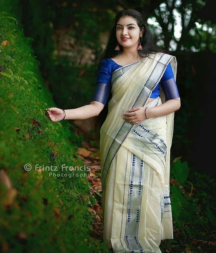 a woman in a sari posing for the camera