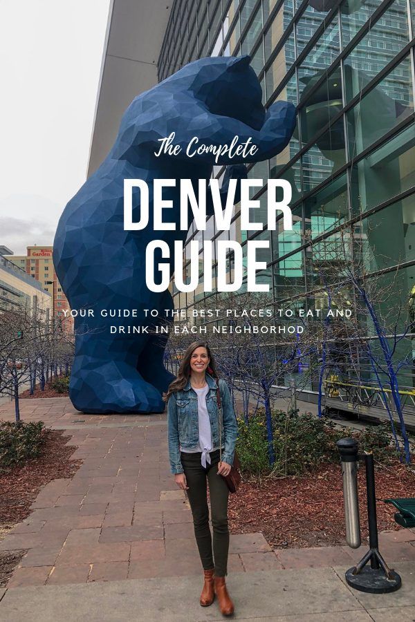 a woman standing in front of a giant blue bear statue with the words, the complete denver guide