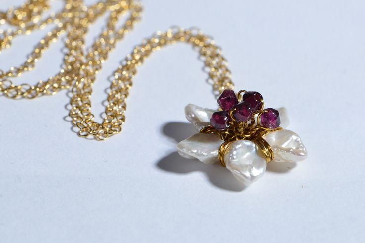 This so feminine jewelry set earrings and pendant Japanese blossom cherry. Craft from natural Keshi Pearl and Rhodolite Garnet wire wrapped 14K gold filled size of this flower 18mm, chain 20 inch secured with trigger clasp earrings : 1 inch with tulip leverback earwire Gold 14/20 New set come in jewelry box. Any question please convo with me, Custom order available ( may be other stone ? I will glad do it for you:-) Thank you for visit my shop Dainty Flower-shaped Pearl Drop Jewelry, Flower Shaped Pearl Drop Jewelry As Gift, White Pearl Drop Flower Pendant Jewelry, Flower-shaped Pearl Drop Jewelry Gift, Flower Shaped Pearl Drop Jewelry Gift, Flower-shaped Pearl Pendant Jewelry For Wedding, Flower Shape Pearl Drop Jewelry For Gifts, Flower Shaped Pearl Drop Jewelry For Gifts, Flower-shaped Pearl Drop Jewelry For Anniversary