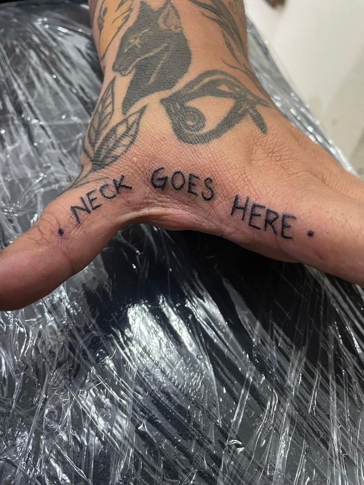 a person's hand with the words nech goes here tattooed on it