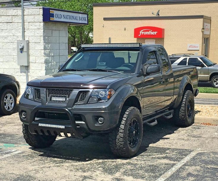 a black truck parked in front of a building