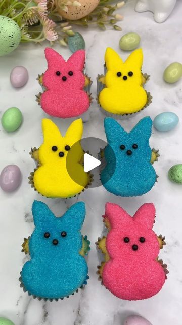 cupcakes decorated with different colored frosting in the shape of bunnies and peeps