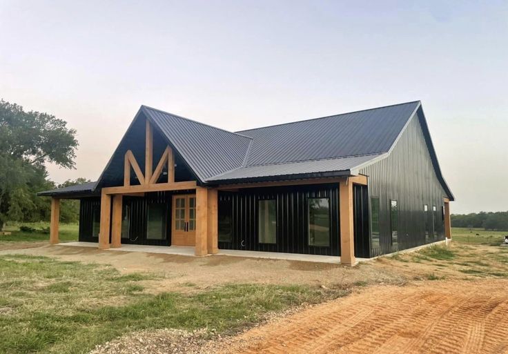 a large house sitting on top of a dirt field