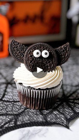 a cupcake with an oreo cookie as the face and ears on it's head