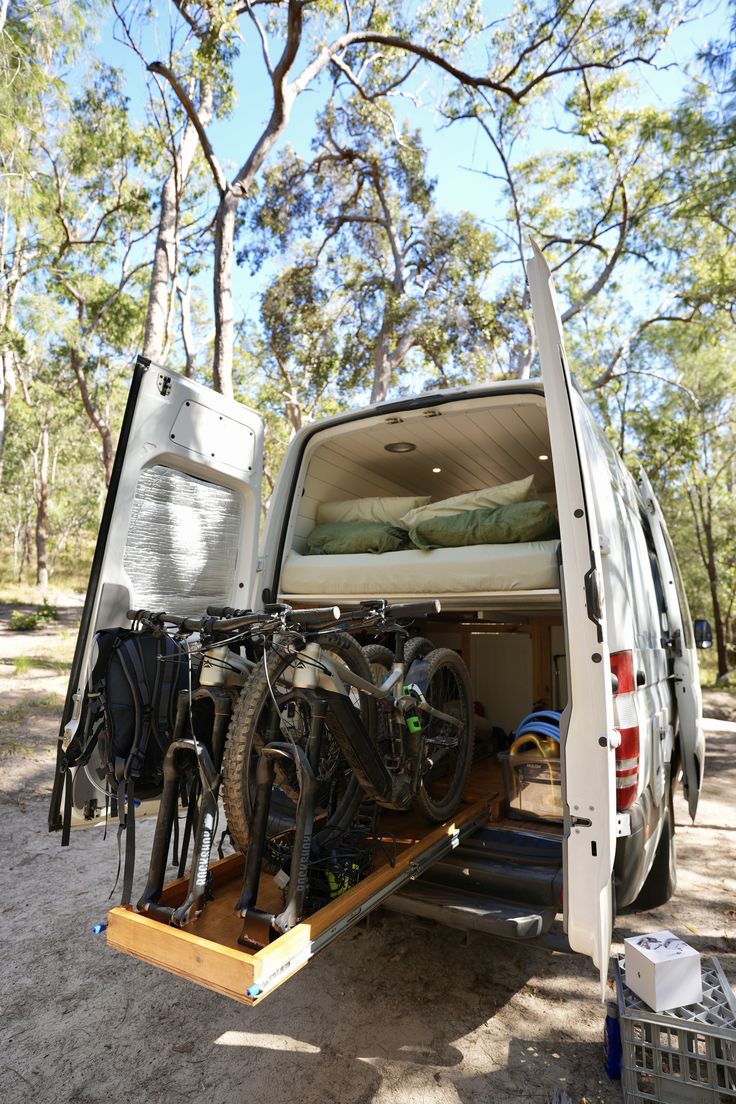 the back end of a van with bikes in it's cargo compartment and storage area