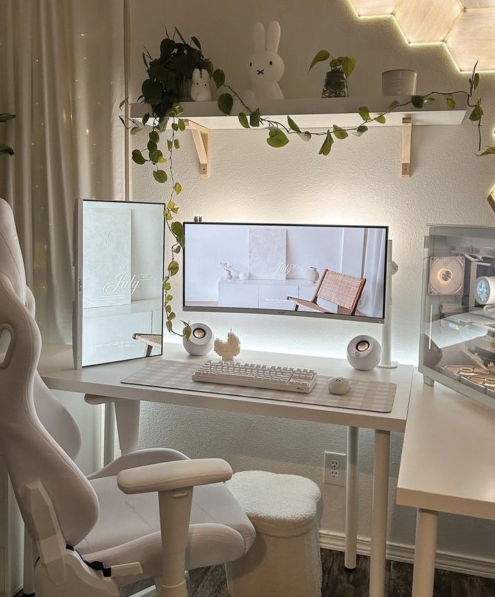 a white desk with a computer monitor and keyboard