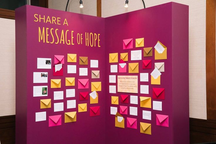 a purple display with yellow and pink envelopes on it's sides that read share a message of hope