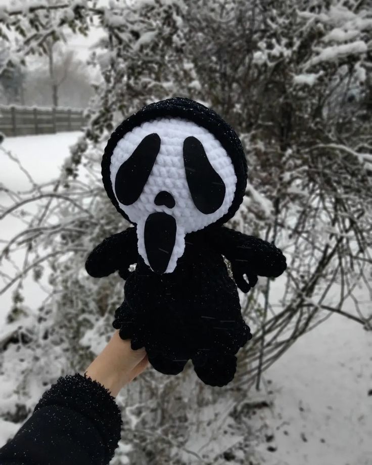 someone is holding up a stuffed animal in the snow