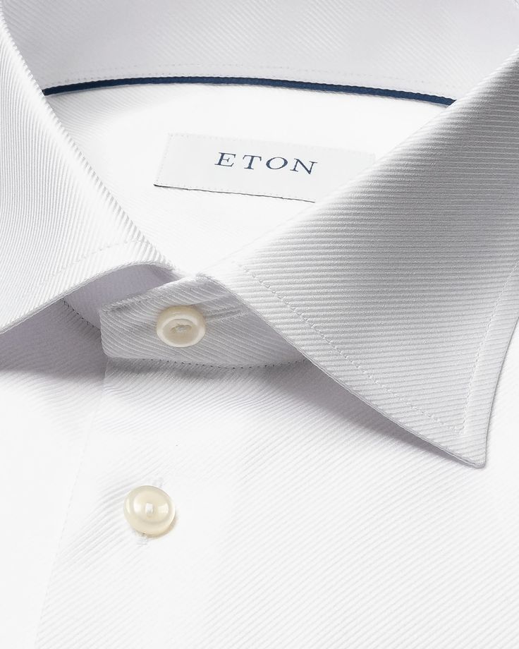 An exquisite classic dress shirt crafted from our textured twill fabric that is distinguished by its structured texture. This modern style statement features a robust and prominent texture while remaining silky soft, setting it apart as a remarkable alternative to traditional dress shirts. Crafted to perfection, it is exceptional for both business and elegant evening attire. Modern Tailored Semi-formal Tops, Modern Tailored Top For Semi-formal Occasions, Designer Formal Tops With Lapel Collar, Timeless Business Top With Concealed Placket, Elegant Formal Tops With Concealed Placket, Tailored Luxury Shirt For Workwear, Luxury Tailored Shirt For Work, Luxury Business Tops With Fold Down Collar, Timeless Business Top With Fold-down Collar